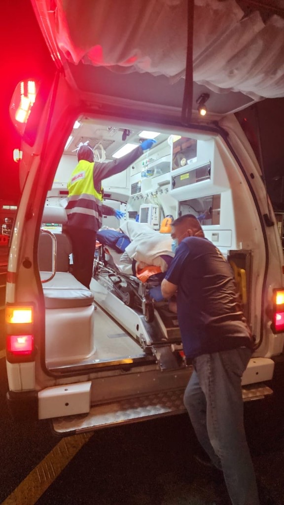 NWAS team loading patient into ambulance at night